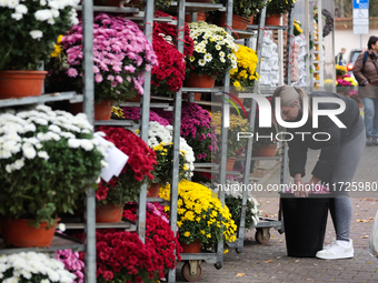 A person works at the stand with flowers near the Rakowicki Cemetery a day ahead of the All Saints Day in Krakow, Poland on October 31, 2024...