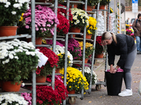 A person works at the stand with flowers near the Rakowicki Cemetery a day ahead of the All Saints Day in Krakow, Poland on October 31, 2024...