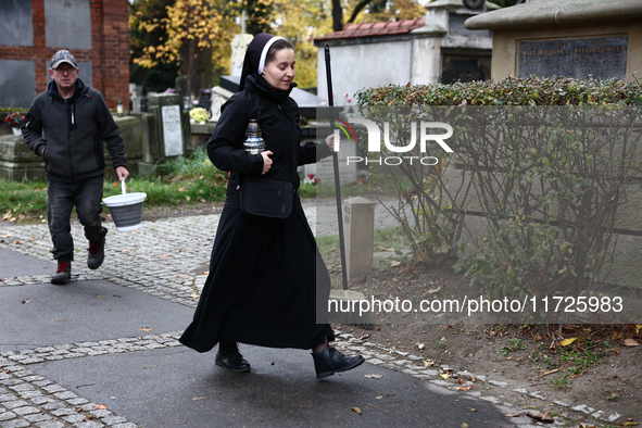 A nun walks at the Rakowicki Cemetery a day ahead of the All Saints Day in Krakow, Poland on October 31, 2024. 