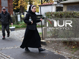 A nun walks at the Rakowicki Cemetery a day ahead of the All Saints Day in Krakow, Poland on October 31, 2024. (