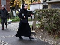 A nun walks at the Rakowicki Cemetery a day ahead of the All Saints Day in Krakow, Poland on October 31, 2024. (