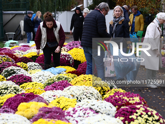 People do shopping at the stand near the Rakowicki Cemetery a day ahead of the All Saints Day in Krakow, Poland on October 31, 2024. (