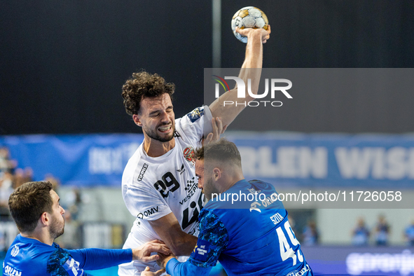 Nedim Remili and Zoltan Szita  are playing during the match EHF Champions League Men match between  Orlen Wisla Plock and Veszprem HC in Plo...