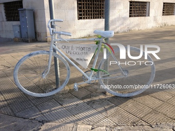 A white-painted ghost bike tied to a pole in Bari, Italy, on April 2, 2013, commemorates the tragic death of a cyclist struck by a car. It b...