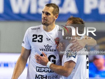 Patrik Ligetvari and Luka Cindric are playing during the match EHF Champions League Men match between  Orlen Wisla Plock and Veszprem HC in...