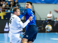 Dragan Pechmalbec and Gergo Fazekas are playing during the match EHF Champions League Men match between  Orlen Wisla Plock and Veszprem HC i...