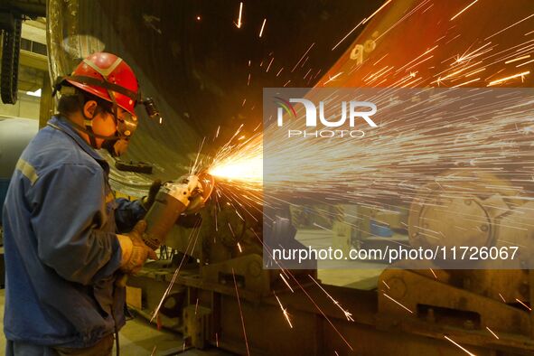 A construction worker builds petrochemical equipment at Lanshi Heavy Machinery Co LTD in Qingdao, China, on October 31, 2024. 