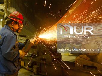 A construction worker builds petrochemical equipment at Lanshi Heavy Machinery Co LTD in Qingdao, China, on October 31, 2024. (