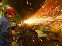 A construction worker builds petrochemical equipment at Lanshi Heavy Machinery Co LTD in Qingdao, China, on October 31, 2024. (