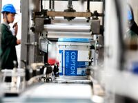 Workers produce lubricating oil on a production line at Qingdao Compton Technology Co LTD in Qingdao, Shandong province, China, on October 3...