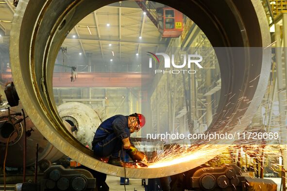 A construction worker builds petrochemical equipment at Lanshi Heavy Machinery Co LTD in Qingdao, China, on October 31, 2024. 