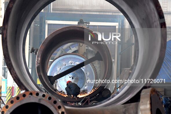 A construction worker builds petrochemical equipment at Lanshi Heavy Machinery Co LTD in Qingdao, China, on October 31, 2024. 