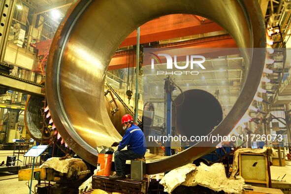 A construction worker builds petrochemical equipment at Lanshi Heavy Machinery Co LTD in Qingdao, China, on October 31, 2024. 