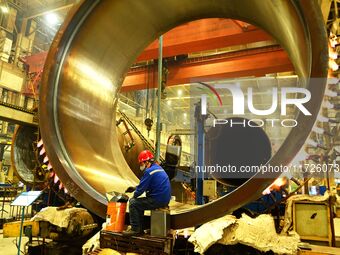 A construction worker builds petrochemical equipment at Lanshi Heavy Machinery Co LTD in Qingdao, China, on October 31, 2024. (