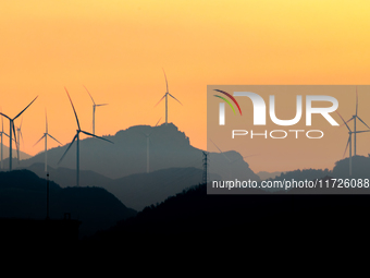 A wind power plant operates at Liangfengya in the Nanchuan district of Chongqing, China, on October 30, 2024. (