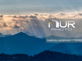 A wind power plant operates at Liangfengya in the Nanchuan district of Chongqing, China, on October 30, 2024. (