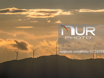 A wind power plant operates at Liangfengya in the Nanchuan district of Chongqing, China, on October 30, 2024. (