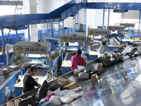 Staff members of the ZTO Express Fuyang Distribution Center use automatic sorting equipment to sort parcels in Fuyang, China, on October 23,...