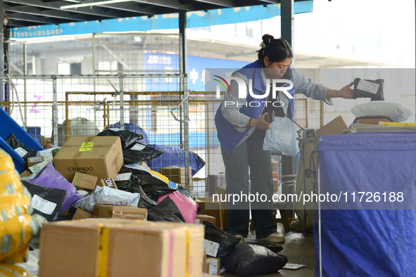 Staff sort parcels at the Fuyang distribution center of ZTO Express in Fuyang, China, on October 23, 2024. 