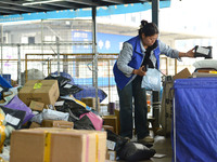 Staff sort parcels at the Fuyang distribution center of ZTO Express in Fuyang, China, on October 23, 2024. (