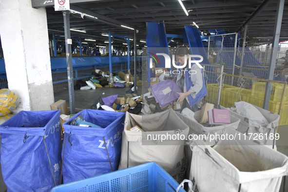 Staff sort parcels at the Fuyang distribution center of ZTO Express in Fuyang, China, on October 23, 2024. 