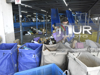 Staff sort parcels at the Fuyang distribution center of ZTO Express in Fuyang, China, on October 23, 2024. (