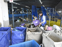 Staff sort parcels at the Fuyang distribution center of ZTO Express in Fuyang, China, on October 23, 2024. (