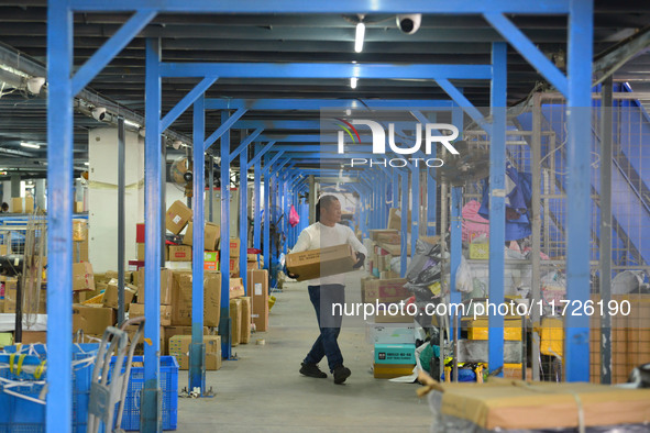 Staff sort parcels at the Fuyang distribution center of ZTO Express in Fuyang, China, on October 23, 2024. 