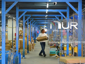 Staff sort parcels at the Fuyang distribution center of ZTO Express in Fuyang, China, on October 23, 2024. (