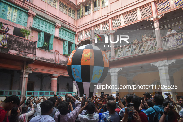 People celebrate The Fanush (a paper-made hot air balloon) festival inside an old house to mark the Diwali festival in Kolkata, India, on Oc...