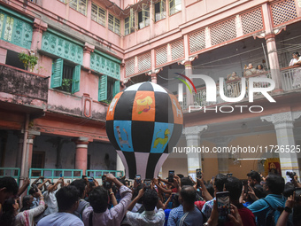 People celebrate The Fanush (a paper-made hot air balloon) festival inside an old house to mark the Diwali festival in Kolkata, India, on Oc...