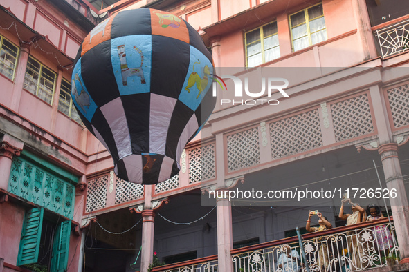 Women take photos during The Fanush (a paper-made hot air balloon) festival inside an old house to mark the Diwali festival in Kolkata, Indi...