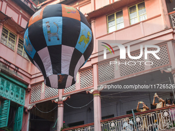 Women take photos during The Fanush (a paper-made hot air balloon) festival inside an old house to mark the Diwali festival in Kolkata, Indi...