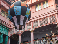 Women take photos during The Fanush (a paper-made hot air balloon) festival inside an old house to mark the Diwali festival in Kolkata, Indi...