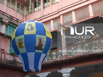 Women take photos during The Fanush (a paper-made hot air balloon) festival inside an old house to mark the Diwali festival in Kolkata, Indi...