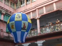 Women take photos during The Fanush (a paper-made hot air balloon) festival inside an old house to mark the Diwali festival in Kolkata, Indi...