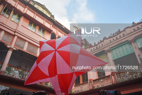 People celebrate The Fanush (a paper-made hot air balloon) festival inside an old house to mark the Diwali festival in Kolkata, India, on Oc...