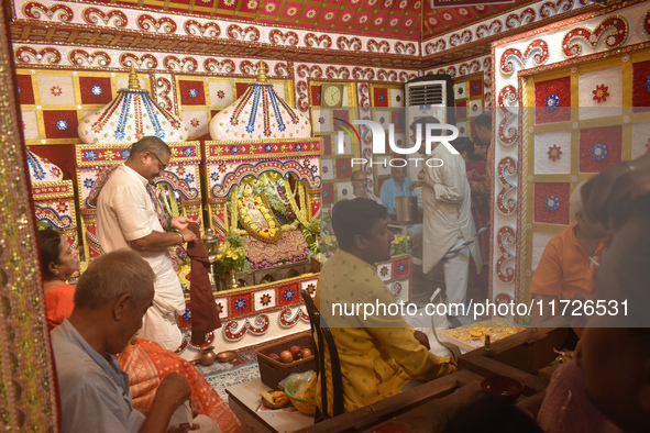 Hindu priests worship Laxmi and Ganesh idols inside a temple on the occasion of the Diwali festival in Kolkata, India, on October 31, 2024. 