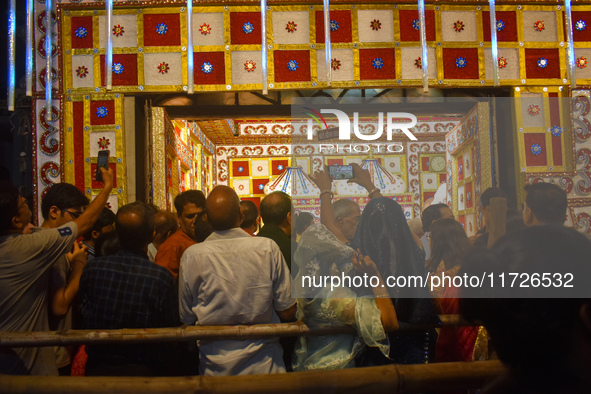 Hindu devotees stand outside a temple to worship Laxmi and Ganesh idols on the occasion of the Diwali festival in Kolkata, India, on October...