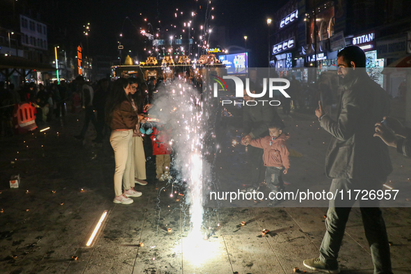 Tourists burst crackers on the day of Diwali in Srinagar, Indian Administered Kashmir, on October 31, 2024. 