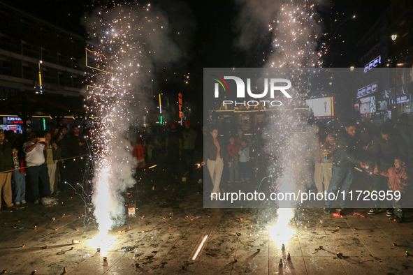 Tourists burst crackers on the day of Diwali in Srinagar, Indian Administered Kashmir, on October 31, 2024. 