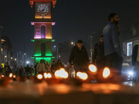 Tourists light candles on the day of Diwali in Srinagar, Indian Administered Kashmir, on October 31, 2024. (