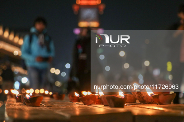 Tourists light candles on the day of Diwali in Srinagar, Indian Administered Kashmir, on October 31, 2024. 