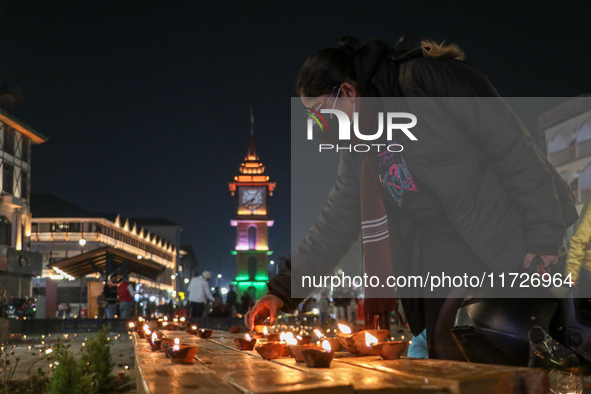 Tourists light candles on the day of Diwali in Srinagar, Indian Administered Kashmir, on October 31, 2024. 