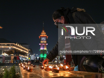 Tourists light candles on the day of Diwali in Srinagar, Indian Administered Kashmir, on October 31, 2024. (