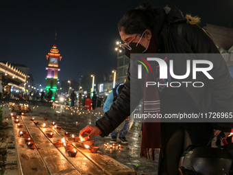 Tourists light candles on the day of Diwali in Srinagar, Indian Administered Kashmir, on October 31, 2024. (