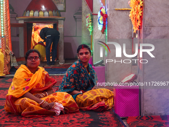 Non-local Hindus sit inside a temple on the day of Diwali in Srinagar, Indian Administered Kashmir, on October 31, 2024. (