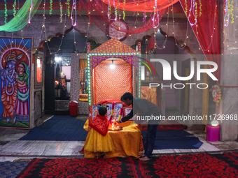 Non-local Hindus sit inside a temple on the day of Diwali in Srinagar, Indian Administered Kashmir, on October 31, 2024. (