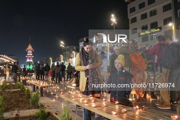 Tourists light candles on the day of Diwali in Srinagar, Indian Administered Kashmir, on October 31, 2024. 