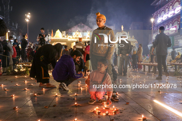 Tourists light candles on the day of Diwali in Srinagar, Indian Administered Kashmir, on October 31, 2024. 